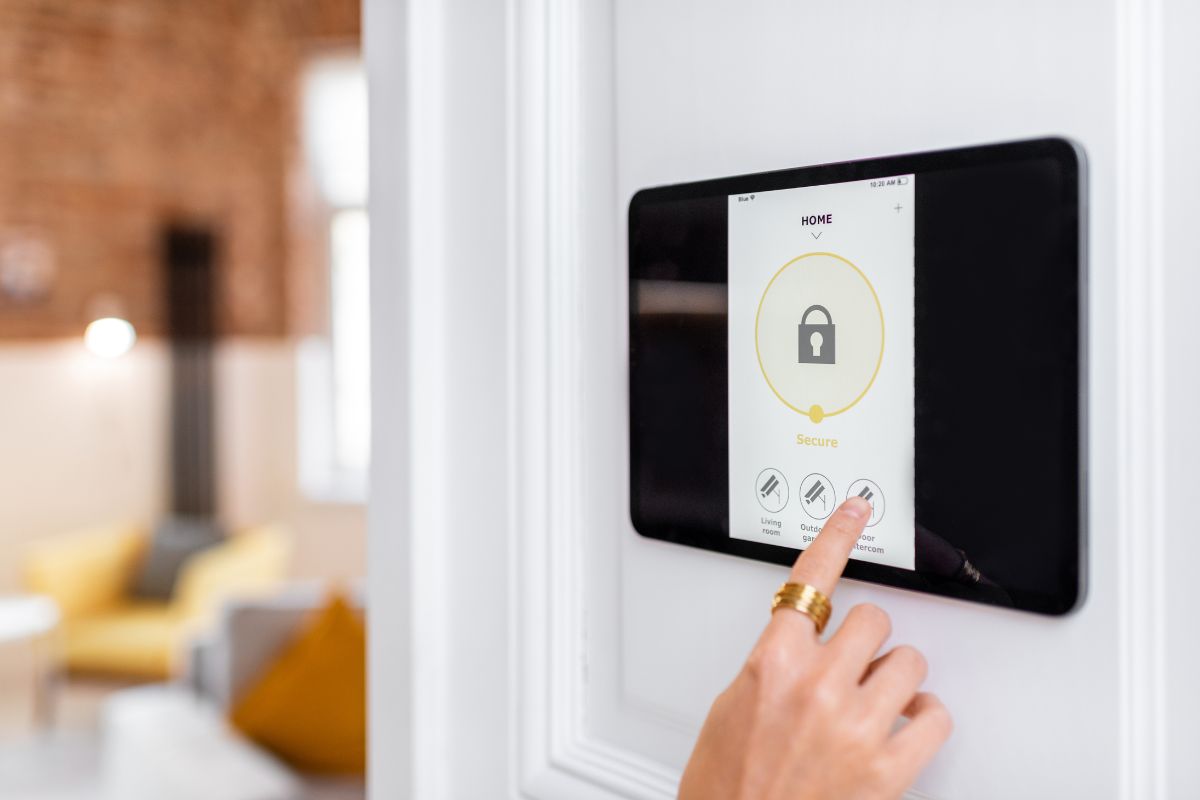 A person pressing a button on a smart home device, indicating interaction with modern technology for home automation. 